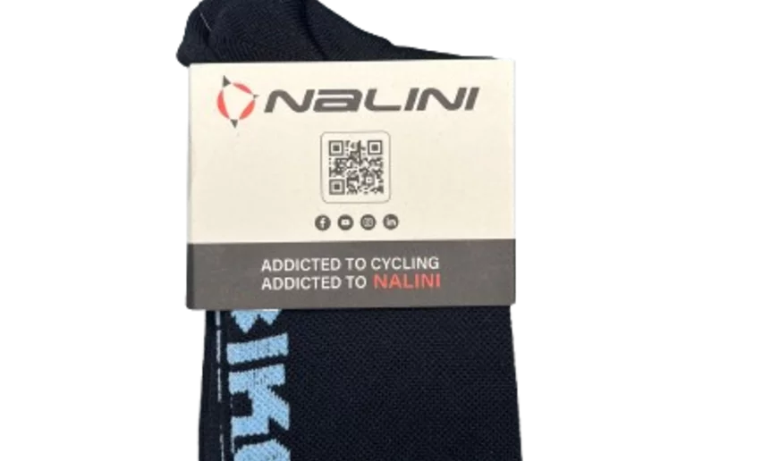 A pair of dark blue cycling socks with light writing. The product is packaged with a Nalini label and a QR code.