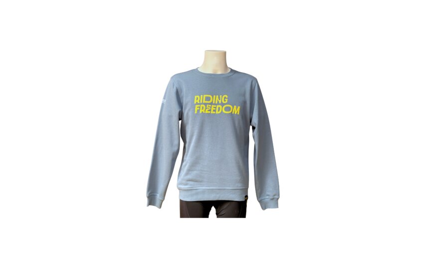 A blue sweater with the yellow writing "RIDING FREEDOM". It is displayed on a mannequin, with long sleeves and a simple design.
